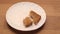 Slice of rye bread and crumbs on plate kitchen table