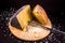 Slice of Sardinian pecorino cheese on a wooden cutting board
