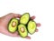Slice small avocado on hand, green healthy fruit holding in hand, has copy space  in white background, clean food healthy.