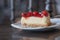 Slice Strawberry cheesecake layer cake Dessert Food on a white plate in the cafe focus blur background