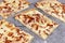 Slice of taditional food `Tarte Flambee` or `Flammkuchen` from German-French Alsace border region