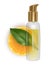 Slice of tangerine with a jar of oil on a white background, Bottle of essential aroma oil on orange slice, fresh leaves on white