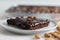 Slice of Texas sheet cake served on a plate. Buttery and chocolaty cake sliced to rectangular pieces inside the baking bin and