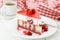 Slice of vanilla sponge cake with yogurt souffle and raspberry j