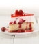 Slice of vanilla sponge cake with yogurt souffle and raspberry j