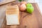 Slice white bread on cutting board with apples  and banana with bowl of fresh green salad in kitchen, healthy food concept