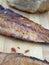 Slice of wild herring fish and traditional bread on wooden background