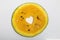 Slice of yellow watermelon on a white background. It has a heart-shaped hole in it