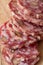 Sliced Air-dried salami with rosemary and cherry tomatoes - wood background