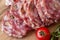 Sliced Air-dried salami with rosemary and cherry tomatoes - wood background