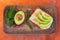 Sliced avocado on bread with fresh green peppercorn