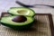 Sliced avocado on the table. Healthy eating, vegetarian tropical food concept. Close up, copy space