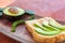 Sliced avocado on toast bread with fresh peppercorn.