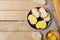 Sliced baguettes on wooden dish with butter on the wooden table