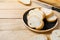 Sliced baguettes on wooden dish with knife on the wooden table