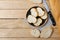 Sliced baguettes on wooden dish with knife on the wooden table