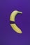 Sliced banana on trendy lavender background. Ultra violet color