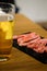 Sliced beef for barbecue grill with glass of beer