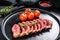 Sliced beef steak Top Blade, black Angus. Black background. Top view