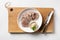 Sliced beef tongue with natural horseradish sauce. Special serving on wooden board and white table.