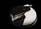Sliced black and white coconut and poppy seed cake on black background