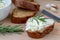 Sliced bread with light cheese on a wooden board