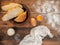 Sliced bread, scattered the flour, salt, egg yolk and tissue. Still life on the background of the old wooden table, top