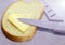 Sliced bread spread with butter or margarine and a knife