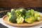Sliced broccoli on wooden plate on the table