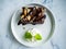 Sliced brownies on white plate on the white table