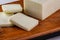 sliced buffalo mozzarella bar on wooden board