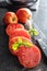 Sliced bull heart tomatoes on black table