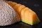 Sliced cantaloupe on black bench