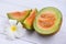 Sliced cantaloupe thai tropical fruit asian and flower on wooden background - Cantaloupe Melon Muskmelon Cucurbitaceae