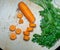 Sliced carrots on the table. Greens and cumin seeds. Soup preparation. Soup ingredient. For a veggie lunch