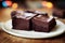 Sliced chocolate brownies on a plate. Selective focus.