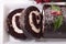 Sliced Christmas yule log cake on plate, above