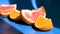 Sliced citrus fruit grapefruit and orange on blue background