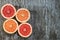 Sliced citrus fruits orange, grapefruit over wooden background