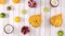 Sliced citrus and tropic fruits blinking on light wooden theme. Stop motion