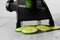 Sliced cucumber with mandoline on a grey wood kitchen worktop