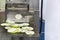 Sliced Cucumber slices on support plate after process chopping by automatic commercial vegetable slicer machine for food