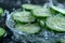 Sliced cucumbers in a bowl of water