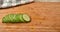 Sliced English cucumber appearing on a cutting board