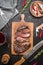 Sliced excellent medium rare grilled beef barbecue Sirloin steak on cutting board on rustic kitchen background with knife, spice