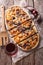 Sliced flammkuchen and red wine close-up. Vertical top view