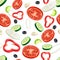Sliced flying vegetables seamless pattern. Salad ingredients on the green background. Tomato, cucumber, onion, red bell pepper, ol