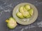 Sliced fresh green radish on a ceramic plate, in the foreground cut into half large radish