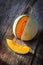 Sliced fresh sweet melon on wooden board. Orang texture and juic
