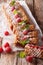 Sliced freshly baked raspberry tart close-up. vertical